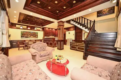 a living room filled with furniture and a staircase at Unique&Nice 7BD pool villa in heart Nanai Patong in Patong Beach