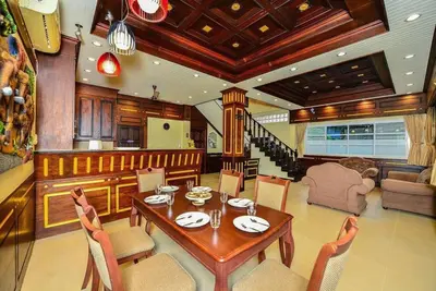 a dining room with a table and chairs at Unique&Nice 7BD pool villa in heart Nanai Patong in Patong Beach