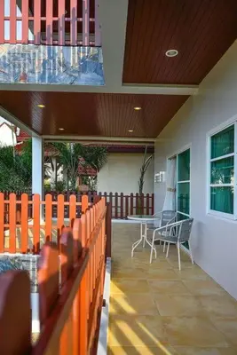 a porch of a house with a table and chairs at Unique&Nice 7BD pool villa in heart Nanai Patong in Patong Beach