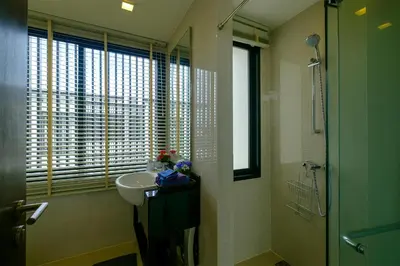 a bathroom with a sink and a shower and a window at 3bdr Townhouse In Laguna Park #116 in Bang Tao Beach