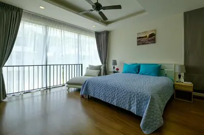 a bedroom with a bed and a large window at 3bdr Townhouse In Laguna Park #116 in Bang Tao Beach