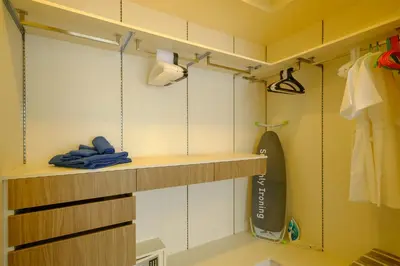 a room with a surfboard on a shelf at 3bdr Townhouse In Laguna Park #118 by Capital Pro in Thalang