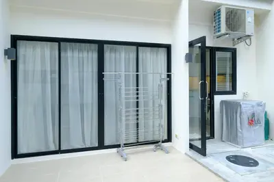a room with a large sliding glass door with a heater at 3bdr Townhouse In Laguna Park #118 by Capital Pro in Thalang