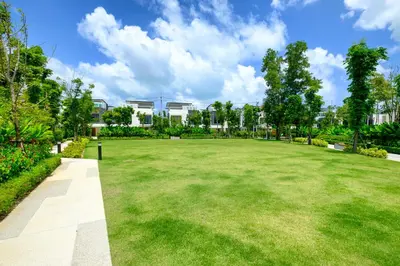 a large grassy field with buildings in the background at 3bdr Townhouse In Laguna Park #118 by Capital Pro in Thalang