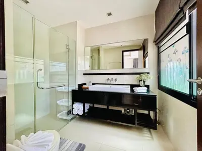 a bathroom with a sink and a glass shower at Country club townhouse in Bang Tao Beach