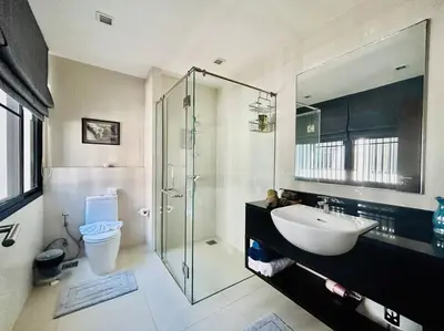 a bathroom with a glass shower and a sink at Country club townhouse in Bang Tao Beach