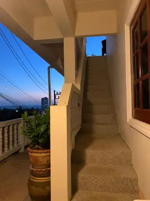 a view from the balcony of a house with stairs at Scan House Apartment in Karon Beach