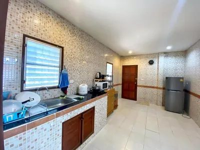 a kitchen with a sink and a counter top at Peaceful 2BR Garden Retreat Bangtao Beach A2 in Ban Thalat Choeng Thale