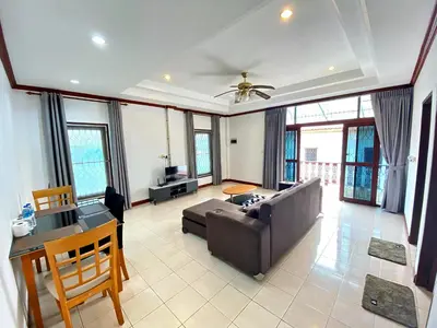 a living room with a couch and a table at Peaceful 2BR Garden Retreat Bangtao Beach A2 in Ban Thalat Choeng Thale