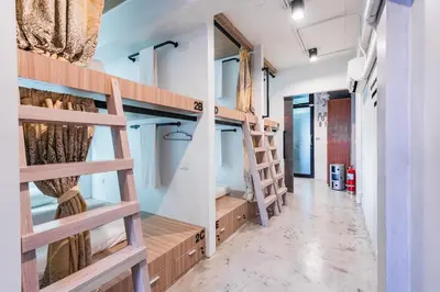 a room with bunk beds and a hallway at Eco Hostel in Phuket Town