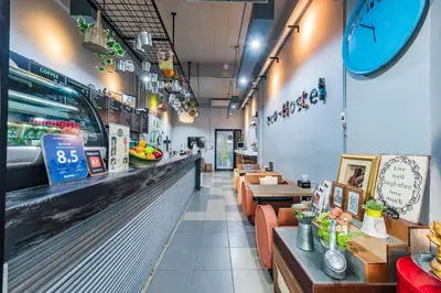 a fast food restaurant with a counter and tables at Eco Hostel in Phuket Town