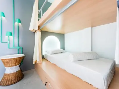 a small bedroom with a bed and a sink at Eco Hostel in Phuket Town
