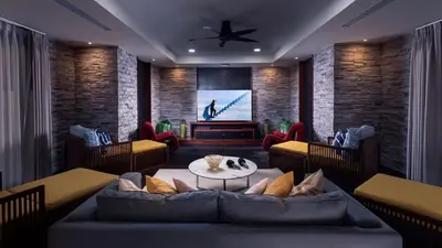 a living room with a couch and a tv at Villa Varya in Amphoe Thalang