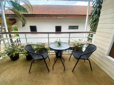 a patio with a table and chairs on a balcony at 2BR Private Villa Natural Stone Style A3 in Ban Thalat Choeng Thale