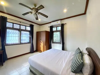 a bedroom with a bed and a ceiling fan at 2BR Private Villa Natural Stone Style A3 in Ban Thalat Choeng Thale