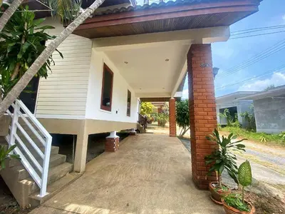 a white house with a porch and a stairway at 2BR Private Villa Natural Stone Style A3 in Ban Thalat Choeng Thale