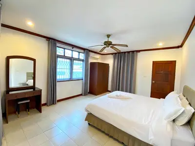 a bedroom with a large bed and a mirror at 2BR Private Villa Natural Stone Style A3 in Ban Thalat Choeng Thale