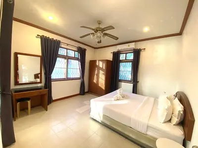 a bedroom with a bed and a ceiling fan at 2BR Private Villa Natural Stone Style A3 in Ban Thalat Choeng Thale