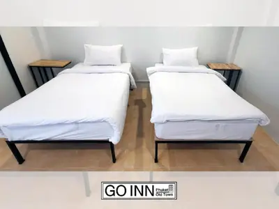 two beds sitting next to each other in a room at xx GO INN Phuket Old Town ภูเก็ตโอลทาวน์ ย่านเมืองเก่า in Phuket Town