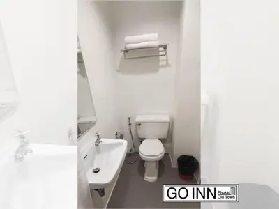 a bathroom with a white toilet and a sink at xx GO INN Phuket Old Town ภูเก็ตโอลทาวน์ ย่านเมืองเก่า in Phuket Town