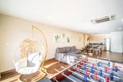 a living room with a couch and a mirror at Patong Tower Superior Seaview 4BR-2101 in Patong Beach