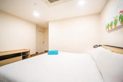 a white room with a bed and a tv at Patong Tower Superior Seaview 4BR-2101 in Patong Beach