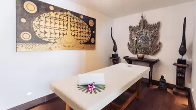 a white table with a bow on it in a room at Villa Purissara in Phuket Town