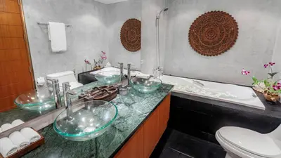 a bathroom with a sink and a tub and a toilet at Villa Lomchoy in Phuket Town