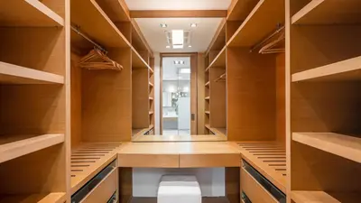 a closet with wooden shelves and a toilet in it at Villa Saengootsa in Phuket Town