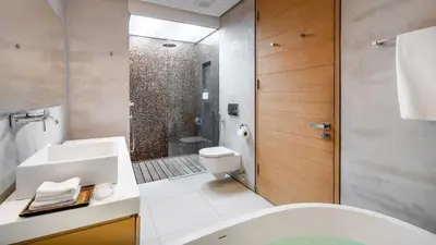 a bathroom with a toilet and a sink and a shower at Villa Saengootsa in Phuket Town