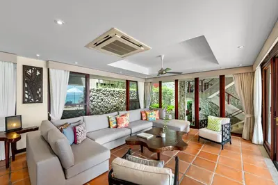 a living room with a couch and a table at Villa Horizon in Phuket Town