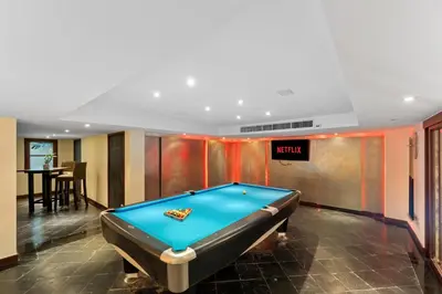 a pool table in a room with a bill at Villa Horizon in Phuket Town