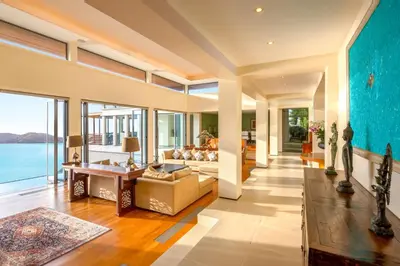 an open living room with a view of the ocean at Villa Fah Sai in Phuket Town