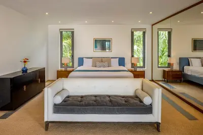a bedroom with a white bed and a couch at Villa Fah Sai in Phuket Town