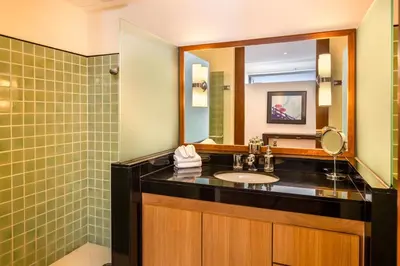a bathroom with a sink and a mirror at Villa Fah Sai in Phuket Town