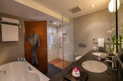 a bathroom with a tub and a sink and a shower at Villa Viman in Kathu