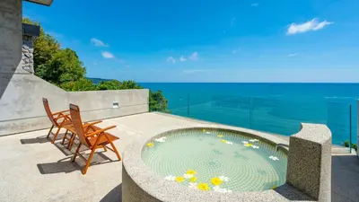 a swimming pool on a patio with a view of the ocean at Villa Viman in Kathu
