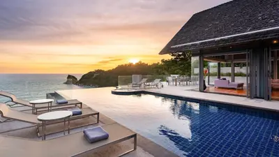 a villa with a swimming pool and the ocean at Villa Viman in Kathu