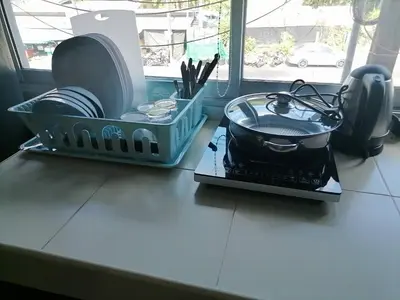 a kitchen counter with dishes and a pot and pans at KARON STUDIO APARTMENT in Karon Beach