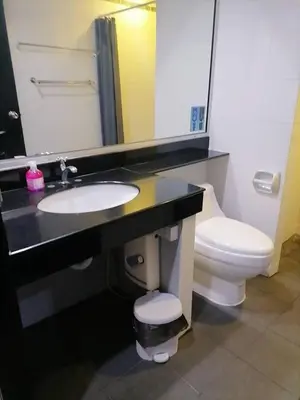 a bathroom with a sink and a toilet and a mirror at KARON STUDIO APARTMENT in Karon Beach
