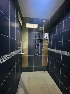 a bathroom with a shower with blue tiles at KARON STUDIO APARTMENT in Karon Beach