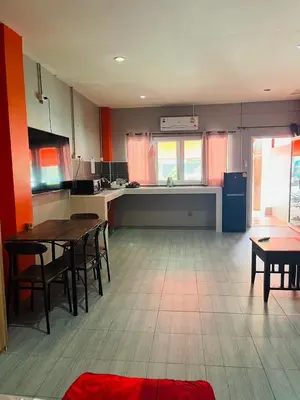 a kitchen with a table and chairs in a room at KARON STUDIO APARTMENT in Karon Beach