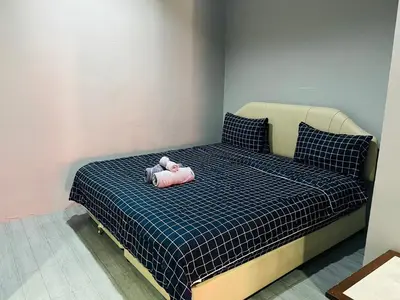 a teddy bear is laying on a bed at KARON STUDIO APARTMENT in Karon Beach