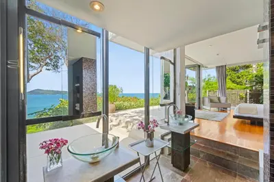 a living room with large windows and a view of the ocean at Villa Hale Malia in Kathu