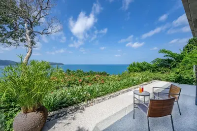 a patio with a table and chairs and the ocean at Villa Hale Malia in Kathu