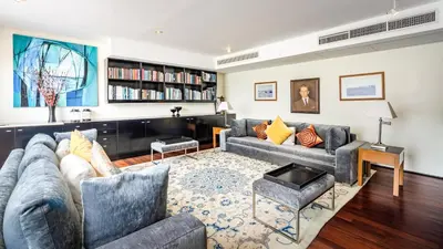 a living room with two couches and a table at Villa Rom Trai in Kathu