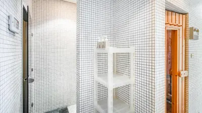 a white shelf in the corner of a bathroom at Villa Rom Trai in Kathu