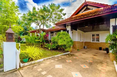 a house with a courtyard in front of it at Recommend a warm Thai style private swimming pool villa with convenient traffic and living, walking 700 meters to the the beach in Kamala Beach