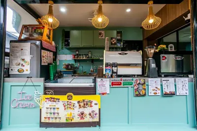 a restaurant kitchen with a counter with aperature at Coco Bella Hotel in Phi Phi Don