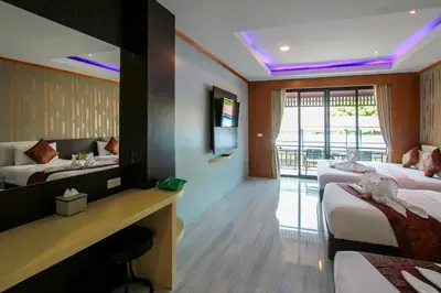 a hotel room with two beds and a mirror at Coco Bella Hotel in Phi Phi Don